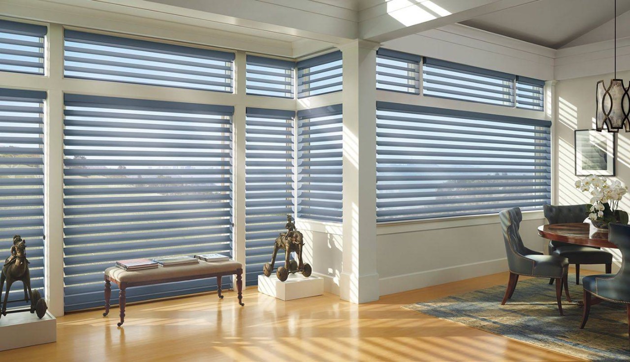 Dining room with many windows all adorned with Hunter Douglas Silhouette® Window Shadings at WTI Window Treatment Installation near Concord, MA
