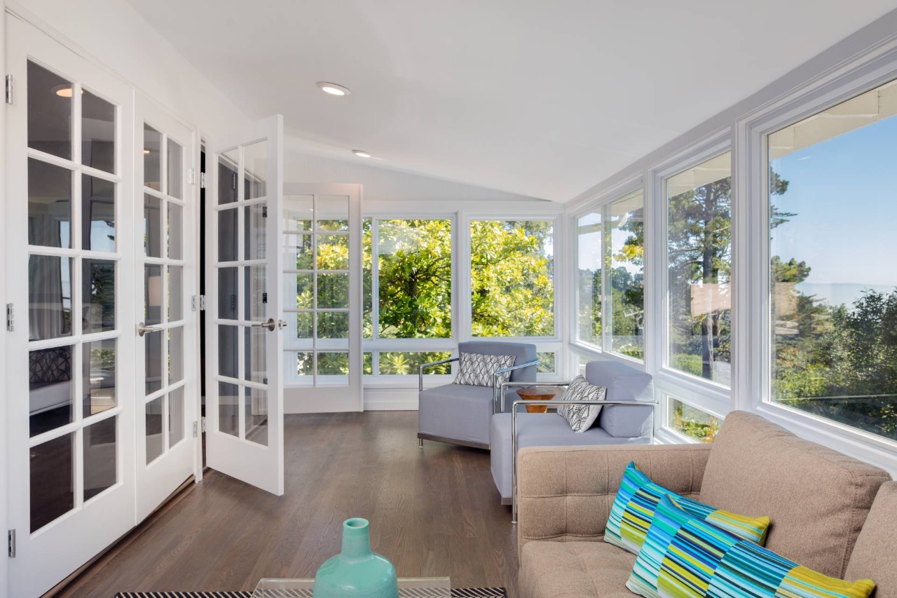  Bright sunroom with French doors and large windows, needing window treatments at  WTI Inc. near Concord, MA