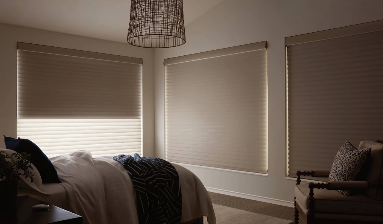 A modern window treatment, Hunter Douglas Silhouette® Sheer Shades, on large windows in a stylish bedroom at  WTI Inc. near Concord, MA