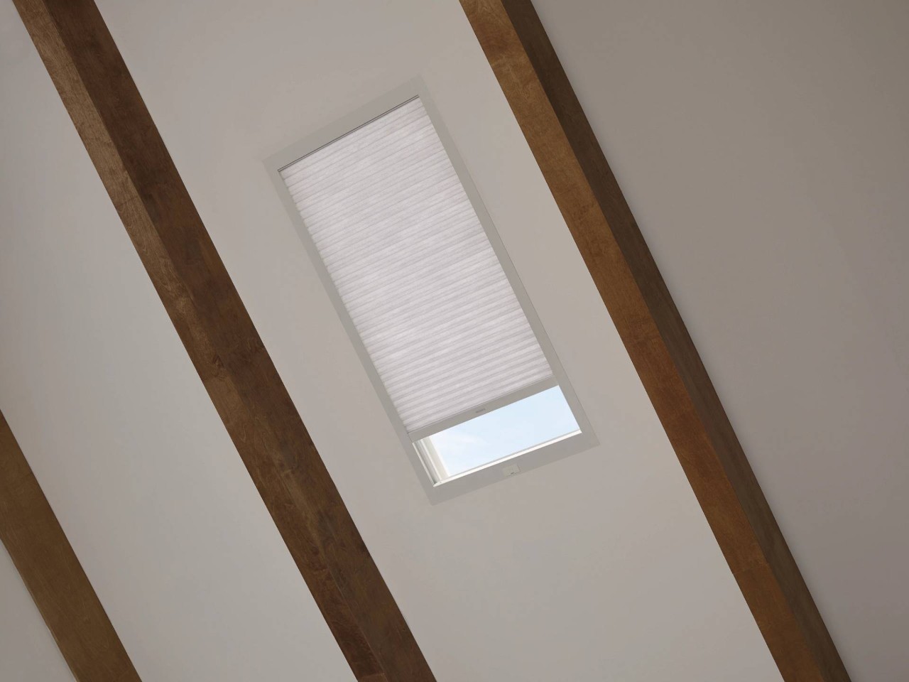 Stylish Hunter Douglas cellular shades on a skylight with architectural wooden beams on the ceiling at WTI near Concord Massachusetts (MA)