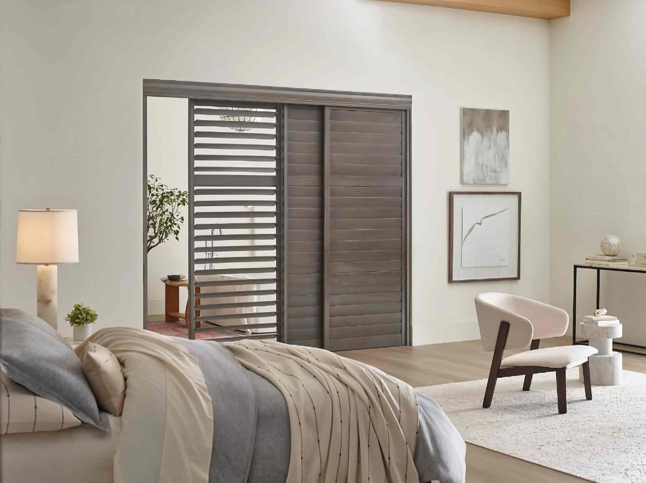 Stunning Hunter Douglas Heritance® Wood Shutters on a bedroom leading into an ensuite bathroom at WTI near Concord Massachusetts (MA)