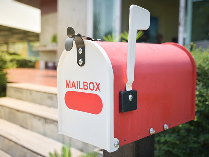 Red and white mailbox that reads mailbox in red